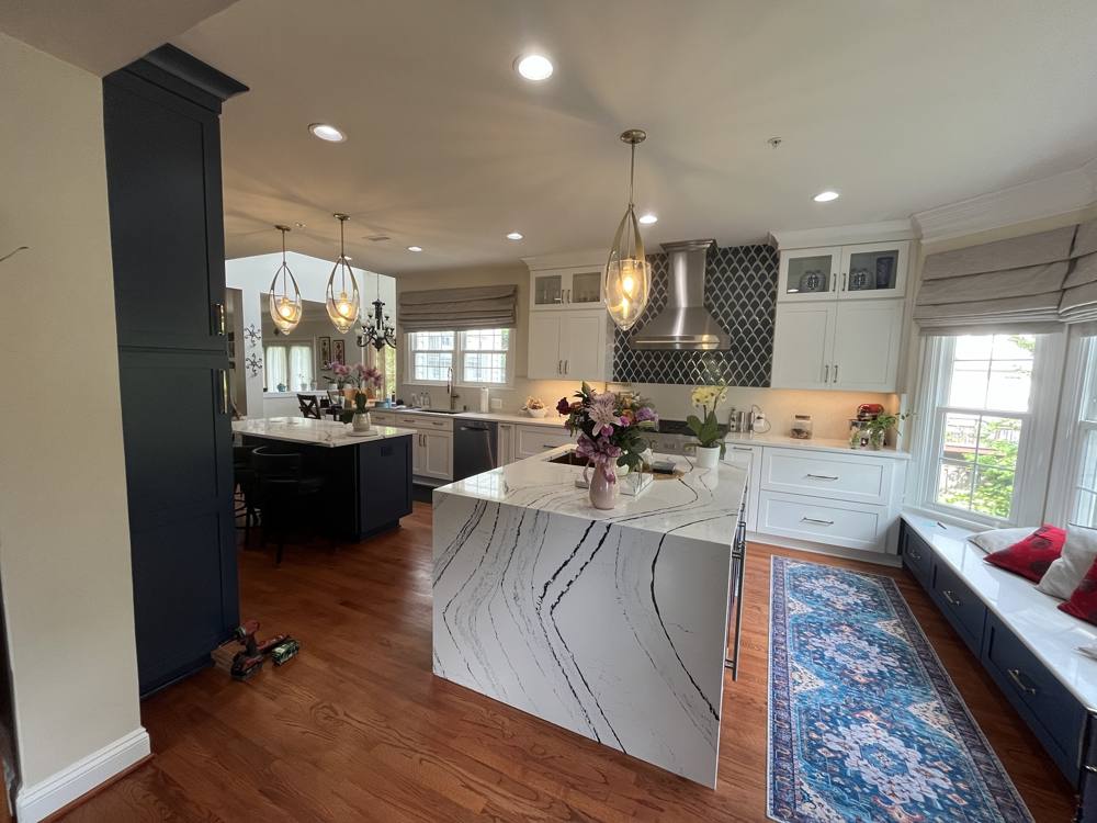 Open kitchen with a marble waterfall island