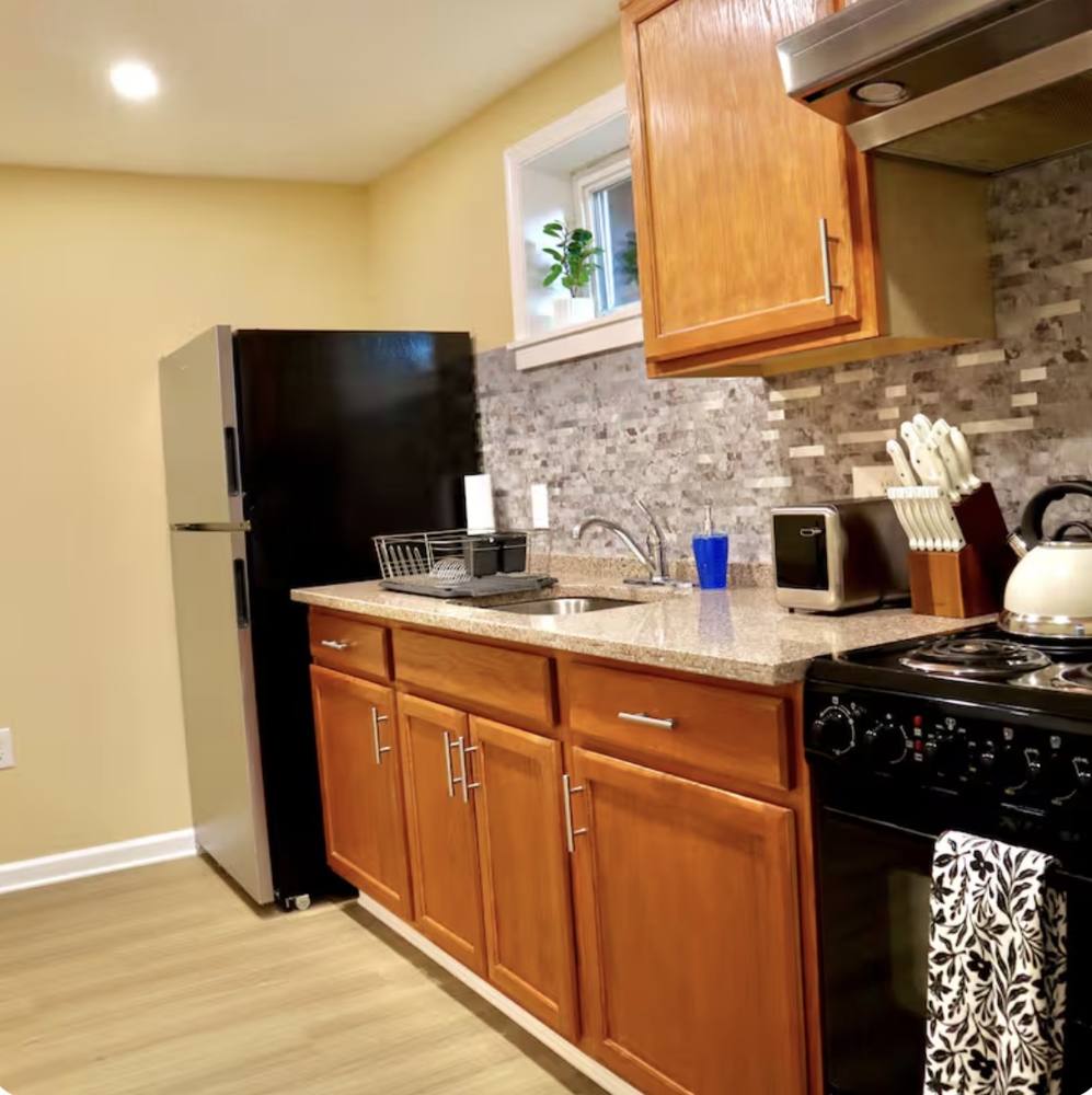 Kitchen with wood cabinets and a stone backsplash