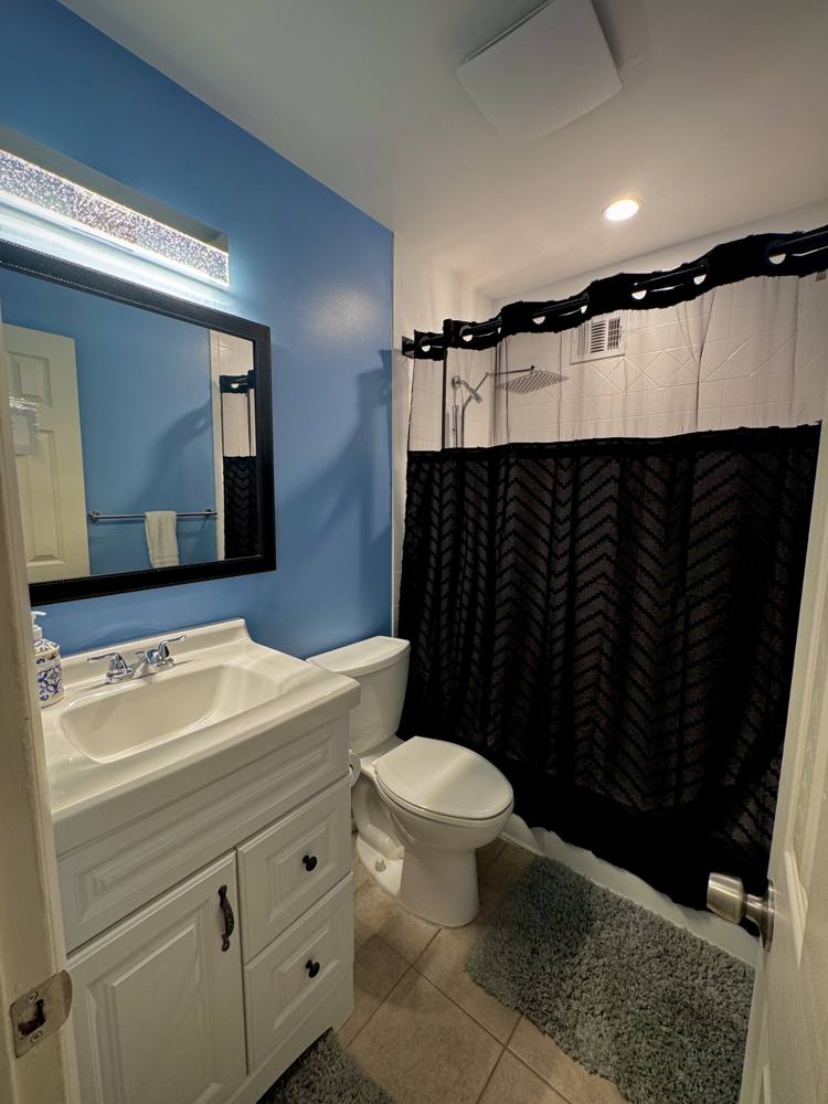 Bathroom with a white vanity and blue walls