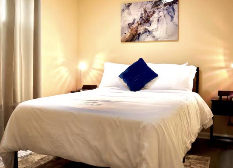 A freshly made bed in a guest-ready room