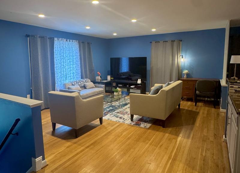 A tidy living room with sofas and a glass coffee table